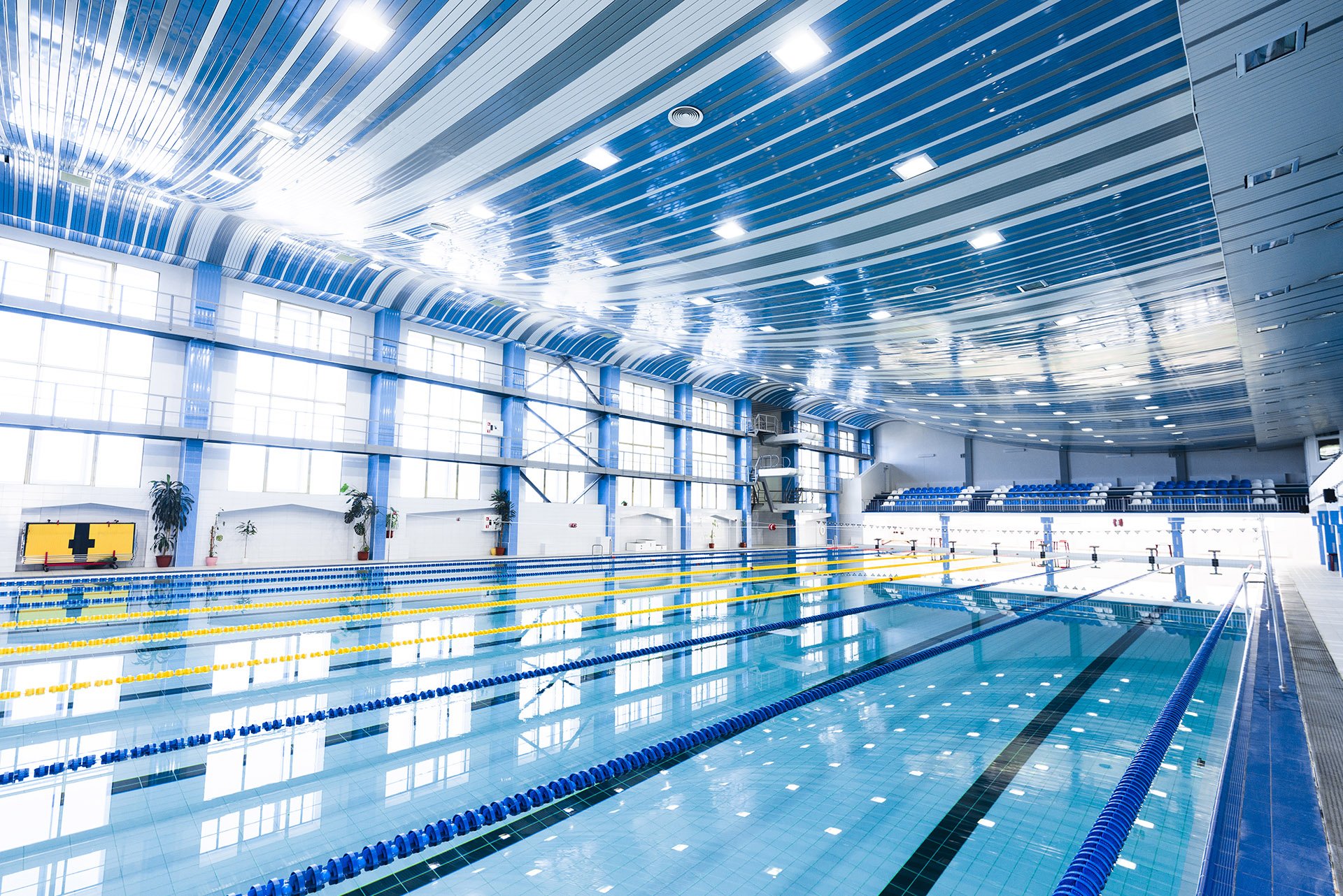 How does technology implementation help reduce costs, improve safety and legal compliance of public swimming pools?